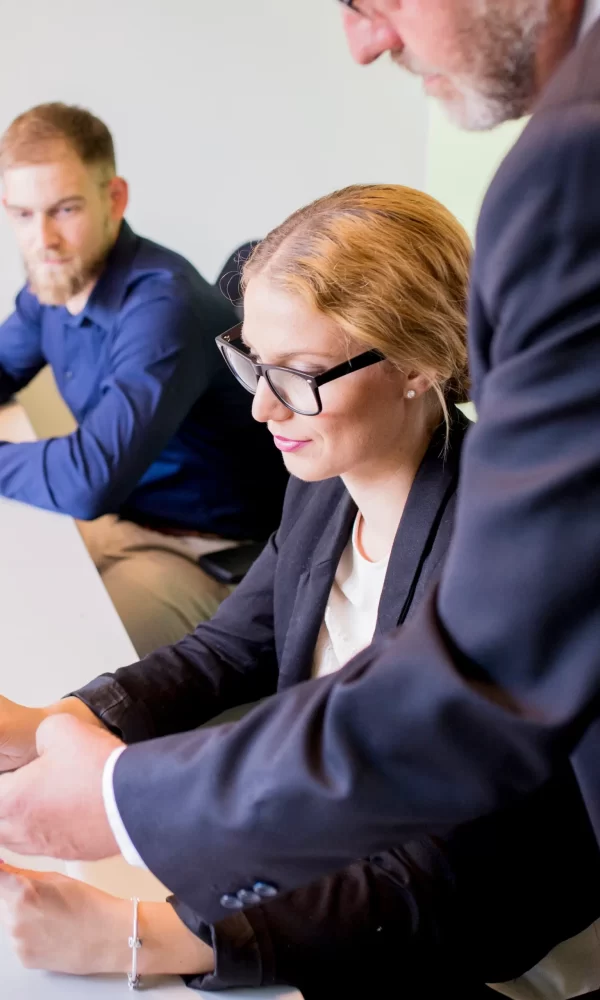 close-up-businessman-showing-business-report-female-colleague